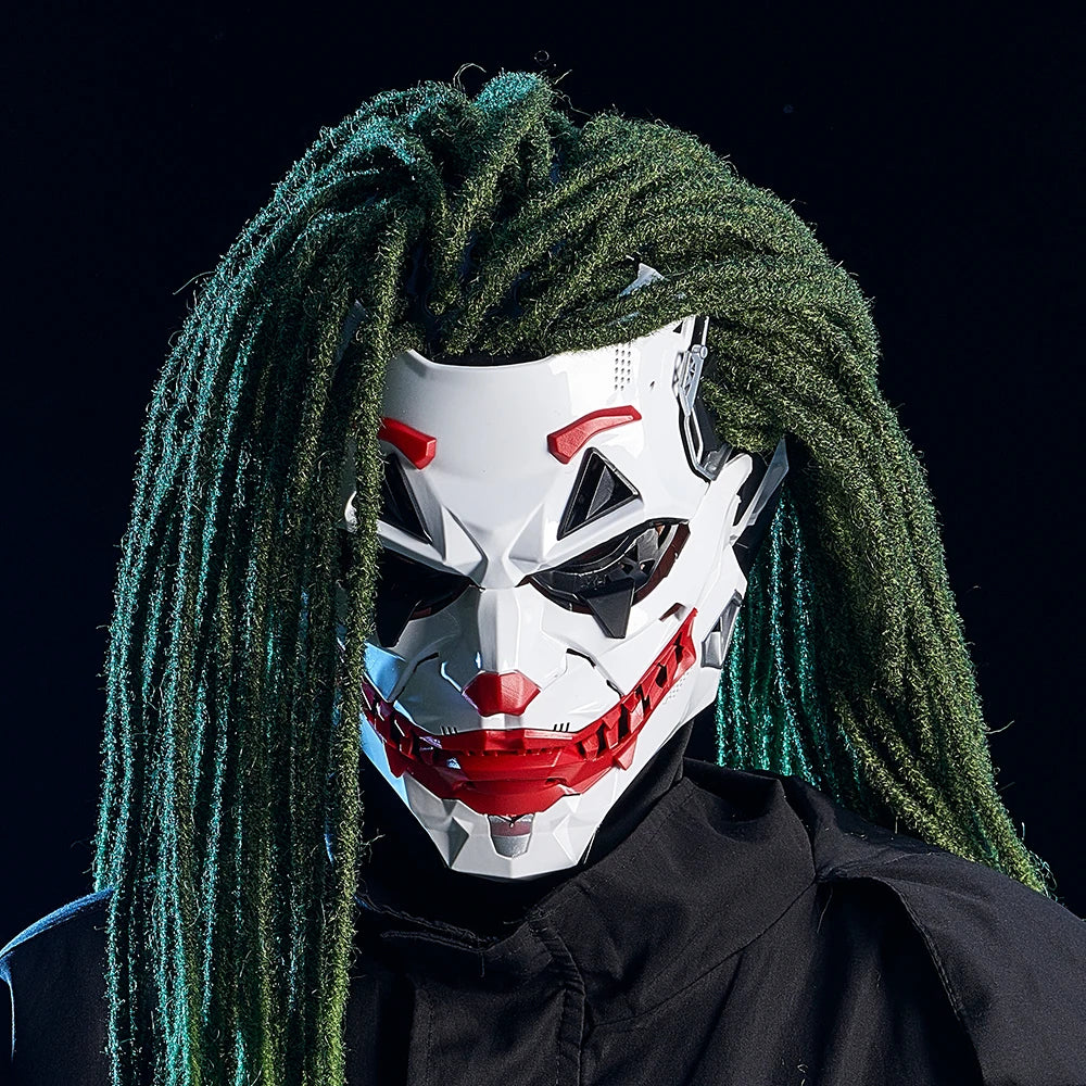 Person wearing a white mask with red accents and green dreadlocks against a black background